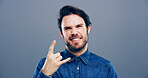 Rocker, hand and metal with portrait of man in studio for funky music, punk identity and crazy. Devil horn sign, edgy and attitude with happy person on background for energy, emoji and expression