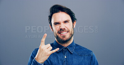 Buy stock photo Rocker, hand and metal with portrait of man in studio for funky music, punk identity and crazy. Devil horn sign, edgy and attitude with happy person on background for energy, emoji and expression