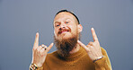 Rocker, hand and rebel with portrait of man in studio for metal music, punk identity and crazy. Devil horn sign, edgy and attitude with cool person on background for energy, emoji and expression