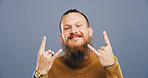 Rocker, hand and cool with man in studio for metal music, punk identity and crazy. Devil horn sign, edgy and attitude with portrait of happy person on background for energy, emoji and expression