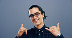 Portrait, man and call me sign at studio, symbol or connection emoji with glasses on background. Hands, smile and person with hang loose, shaka gesture or communication to get in touch with contact