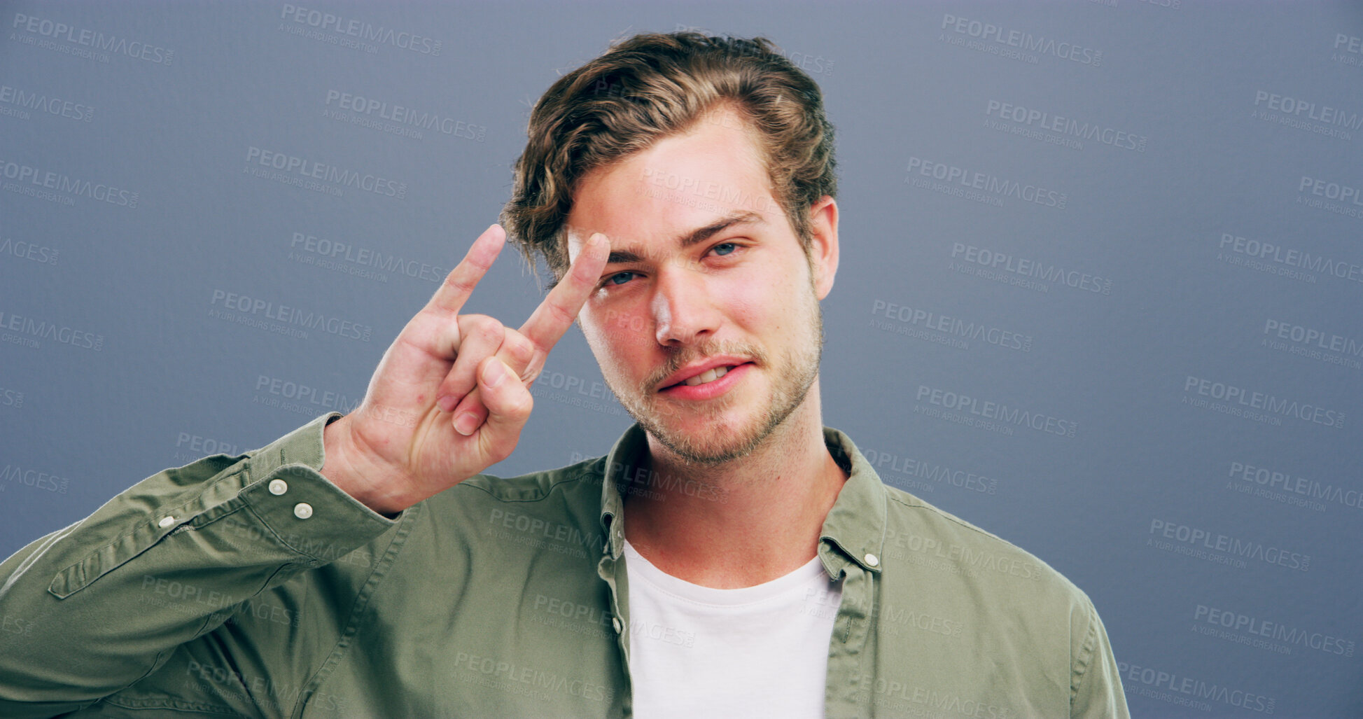 Buy stock photo Rocker, hand and edgy with man in studio for metal music, punk identity and smile. Devil horn sign, cool and attitude with portrait of happy person on background for energy, emoji and expression