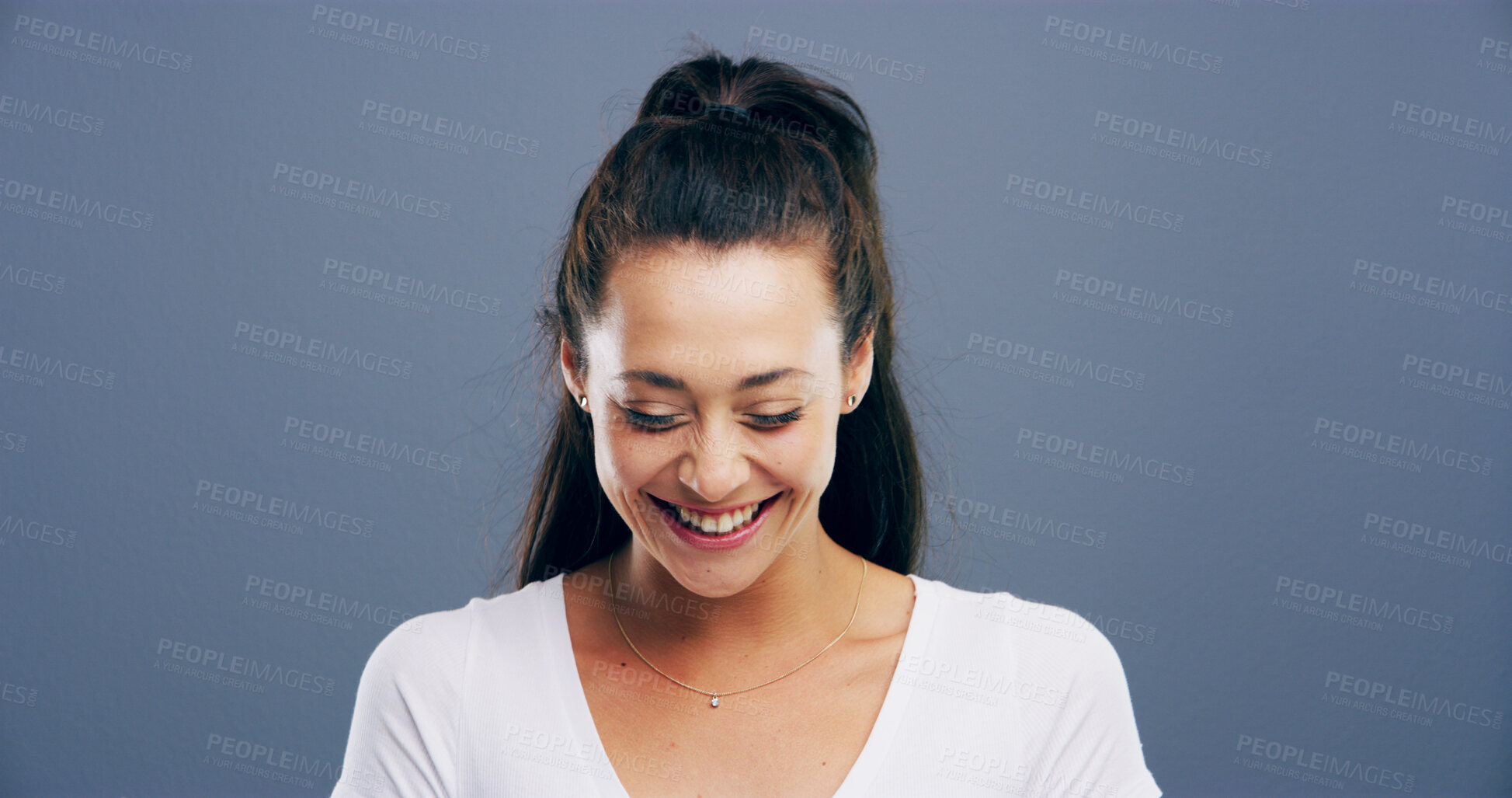 Buy stock photo Happy, laughing and space with woman in studio for comedy, humor or playful joking. Comic, funny and silly with smile of excited model isolated on gray background mockup for reaction to good news