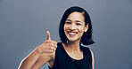 Thumbs up, happy and portrait of woman in studio with hand gesture for success, approve and agreement. Mockup space, smile and person with emoji for support, yes and thank you on gray background