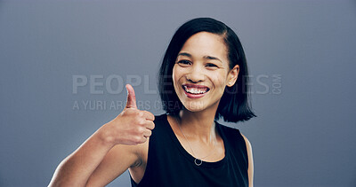 Buy stock photo Thumbs up, happy and portrait of woman in studio with hand gesture for success, approve and agreement. Mockup space, smile and person with emoji for support, yes and thank you on gray background