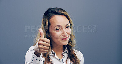 Buy stock photo Happy woman, portrait and feedback with thumbs up in studio for good reaction on a gray background. Female person, model or smile with like emoji, ok or yes sign for positive approval or satisfaction