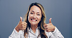 Thumbs up, excited and portrait of woman in studio for approval, success and feedback. Like emoji, yes sign and agreement with female person on background for vote, symbol and promotion icon 
