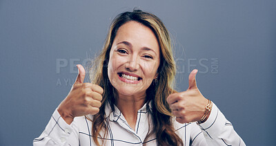 Buy stock photo Thumbs up, excited and portrait of woman in studio for approval, success and feedback. Like emoji, yes sign and agreement with female person on gray background for vote, symbol and promotion icon 