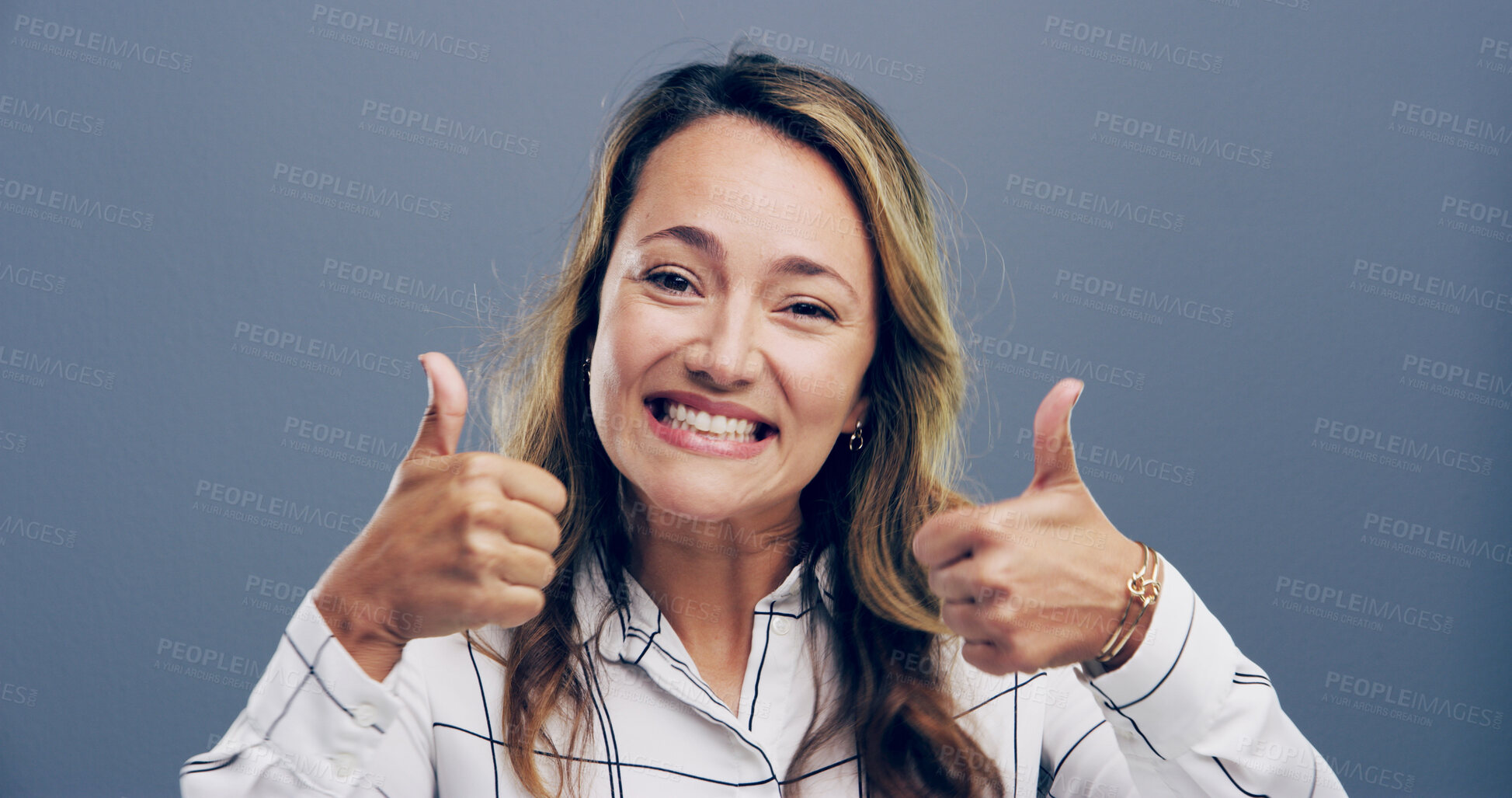 Buy stock photo Thumbs up, excited and portrait of woman in studio for approval, success and feedback. Like emoji, yes sign and agreement with female person on gray background for vote, symbol and promotion icon 