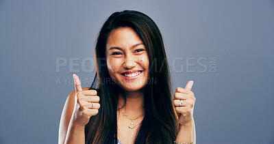 Buy stock photo Thumbs up, smile and portrait of Asian woman in studio for approval, success and feedback. Like emoji, yes sign and agreement with female person on background space for vote, symbol or promotion icon