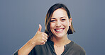 Thumbs up, achievement and portrait of woman in studio for approval, success and feedback. Like emoji, yes sign and agreement with female person on background for vote, symbol and promotion icon 