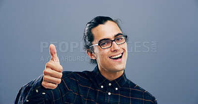 Buy stock photo Happy man, portrait and feedback with thumbs up in studio for good reaction on a gray background. Male person, model or smile with like emoji, ok or yes sign for positive approval or satisfaction