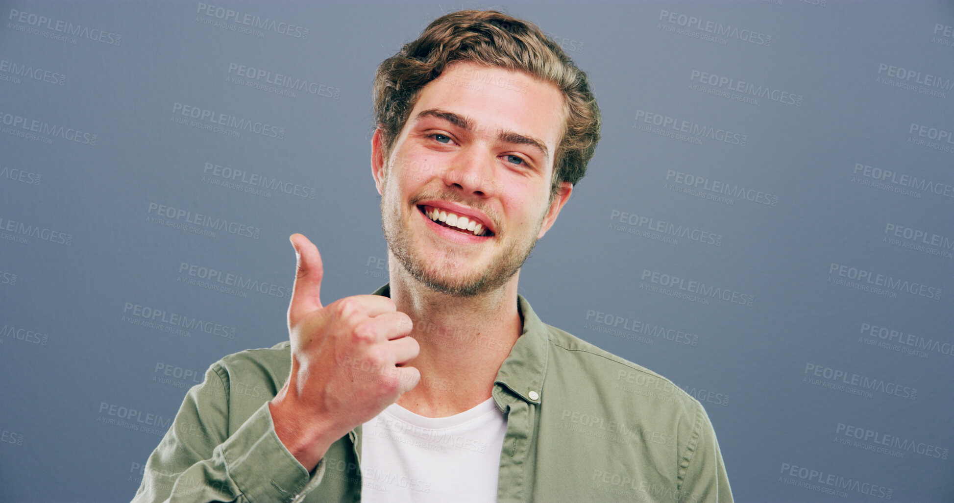 Buy stock photo Happy man, portrait and feedback with thumbs up for good reaction on a gray studio background. Male person, model or smile with like emoji or yes sign for positive approval or satisfaction on space