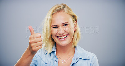 Buy stock photo Happy woman, portrait and feedback with thumbs up for good reaction on a gray studio background. Female person, model or smile with like emoji, ok or yes sign for positive approval or satisfaction