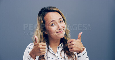 Buy stock photo Happy woman, portrait and feedback with thumbs up for reaction on a gray studio background. Female person, model or smile with like emoji, gesture or yes sign for positivity, approval or satisfaction