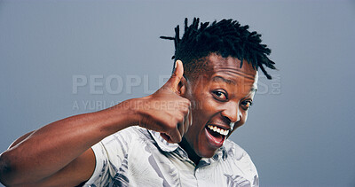 Buy stock photo Happy, black man or portrait with thumbs up for good reaction on a gray studio background. Face, male person or Nigerian model or smile with like emoji, ok or yes sign for approval or satisfaction