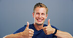 Thumbs up, smile and vote with portrait of man in studio for approval, success and feedback. Like emoji, yes sign and agreement with male person on background for happy, symbol and promotion icon 