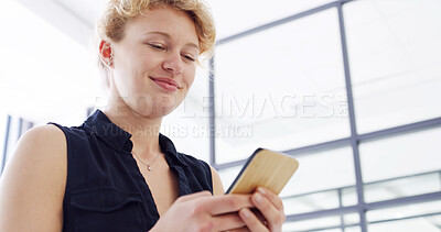 Buy stock photo Happy woman, business and creative with phone for social media, communication or news at office below. Female person, designer or employee with smile on mobile smartphone for texting or chatting app