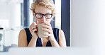 Woman, designer and drinking coffee with laptop for morning beverage, thought or creative inspiration. Female person, employee or thinking with glasses or cup on computer for caffeine at workplace
