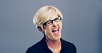 Wink, happy and portrait of mature woman in studio for well done, achievement and good luck. Smile, space and person with gesture, emoji and sign for secret, agreement and support on blue background
