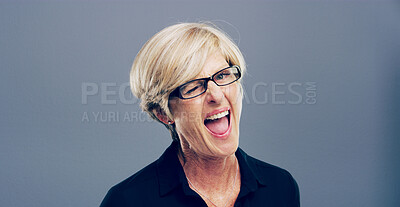 Buy stock photo Wink, happy and portrait of mature woman in studio for well done, achievement and good luck. Smile, space and person with gesture, emoji and sign for secret, agreement and support on gray background