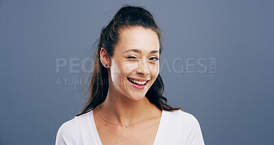 Buy stock photo Wink, smile and portrait of woman in studio for secret, agreement and support gesture. Happiness, feedback and thank you with female person on background for review, rumor and well done sign