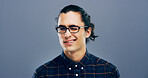 Wink, glasses and portrait of man in studio for secret, agreement and support gesture. Happiness, feedback and thank you with male person on background for review, achievement and well done sign