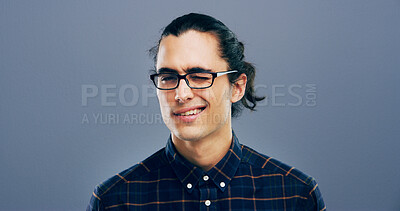 Buy stock photo Wink, glasses and portrait of man in studio for secret, agreement and support gesture. Happiness, feedback and thank you with male person on background for review, achievement and well done sign
