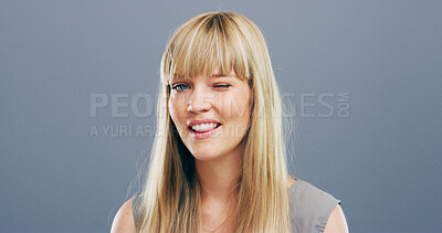 Buy stock photo Wink, flirty and portrait of woman in studio for secret, agreement and support gesture. Happiness, feedback and thank you with female person on background for review, achievement and well done mockup