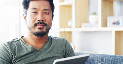 Buy stock photo Tablet, relax and portrait of Asian man on sofa for social media, streaming and networking app. Online post, newsletter and update with person in living room at home for chat, comment and contact