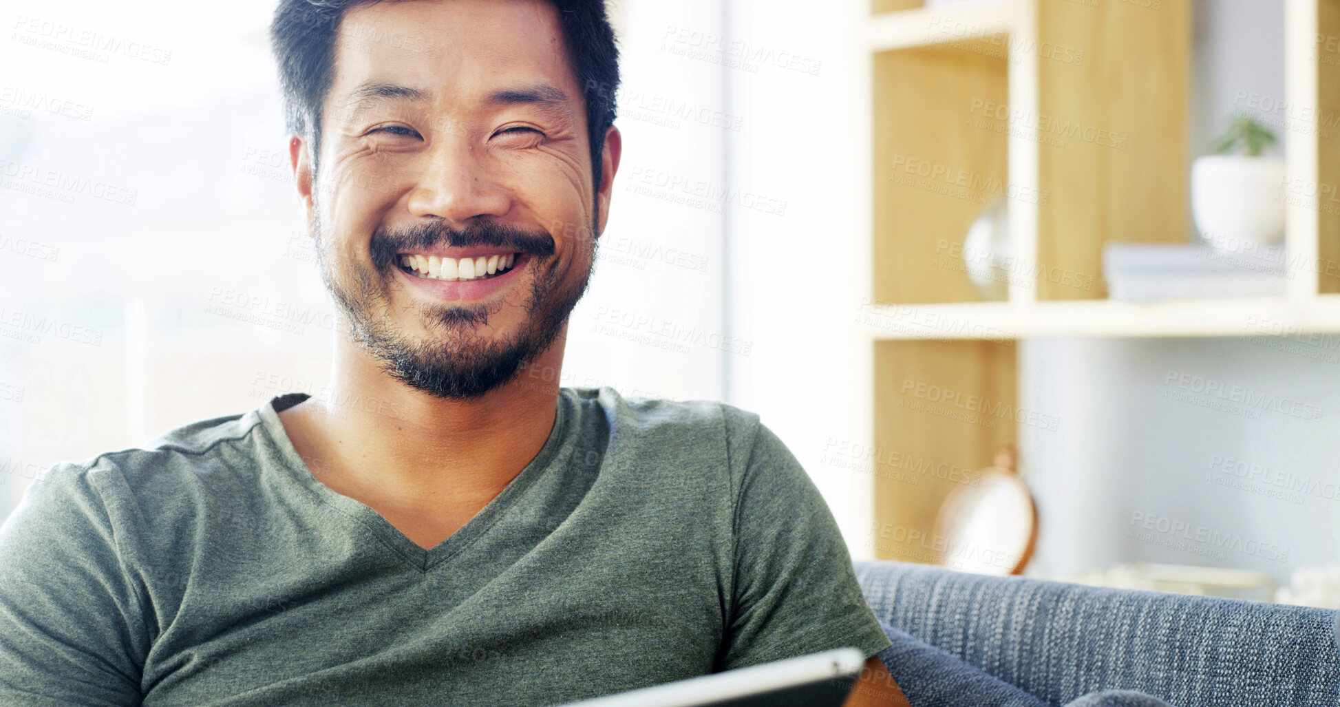 Buy stock photo Tablet, smile and portrait of Asian man on sofa for social media, streaming and networking app. Online post, newsletter and update with person in living room at home for chat, comment and contact