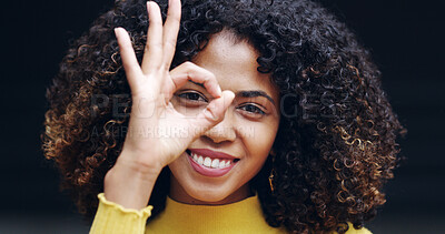 Buy stock photo Okay sign, happy and portrait of woman in studio with hand gesture for success, support and approval. Relax, black background and person smile with emoji on eye for agreement, good news and yes
