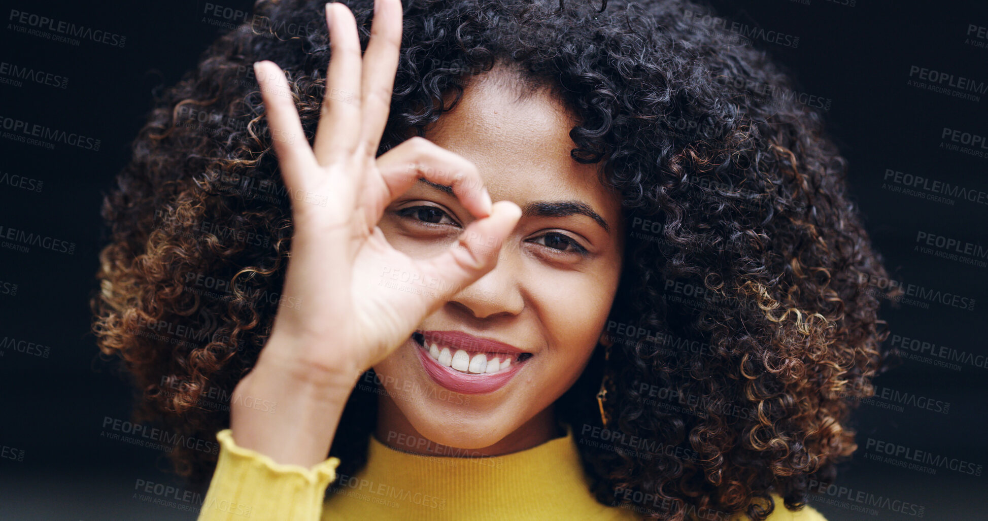 Buy stock photo Okay sign, happy and portrait of woman in studio with hand gesture for success, support and approval. Relax, black background and person smile with emoji on eye for agreement, good news and yes