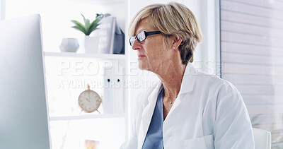 Buy stock photo Mature woman, doctor and computer with research for medical discovery, study or pharmaceutical development. Female person, surgeon or health professional with technology or notes for clinic schedule
