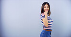 Portrait, happy and woman for pointing in studio of university announcement, scholarship news or sign up. Smile, student and show direction with education steps, information guide and blue background