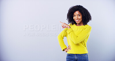 Buy stock photo Advertising, portrait and woman with pointing in studio for promotion deal, coming soon announcement and mockup. Marketing, space and african girl with gesture for sale opportunity on blue background