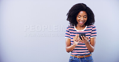 Buy stock photo Excited woman, phone and studio with internet for online communication, social media and mockup. Happy person, cellphone and typing for survey success, feedback and competition win on grey background