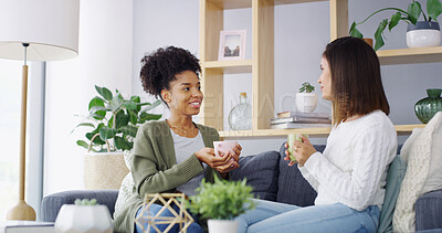 Buy stock photo Home, coffee and women on sofa, talking and bonding together in living room. People, relax and happy friends with cappuccino, gossip and support with comfort, share secret and weekend break in lounge