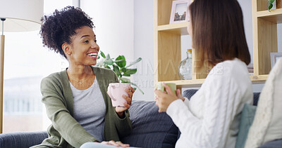 Buy stock photo Home, coffee and women on couch, discussion and bonding together in living room. People, comfort and friends with cappuccino, gossip and support with conversation, relax and weekend break in lounge