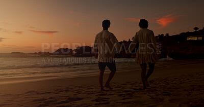 Buy stock photo Sunset, holding hands and couple with walking on beach, vacation holiday and bonding together for date. Back, man and woman with peace for love, travel adventure or connection space in relationship