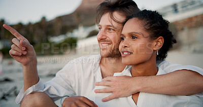 Buy stock photo Hug, couple and relax with conversation on beach, vacation holiday and bonding together for anniversary. Point, man and woman in relationship for love embrace, travel adventure or connection on ocean