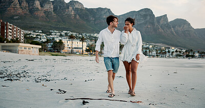 Buy stock photo Walking, holding hands and couple kiss at beach for love, care and interracial relationship. Seashore, happy man and woman outdoor for summer holiday, travel or romantic date with partner for support