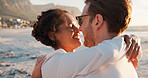 Happy couple, vacation and hug at beach for love, care and interracial relationship together. Seashore, man and woman embrace outdoor for summer holiday, travel and romantic date for connection