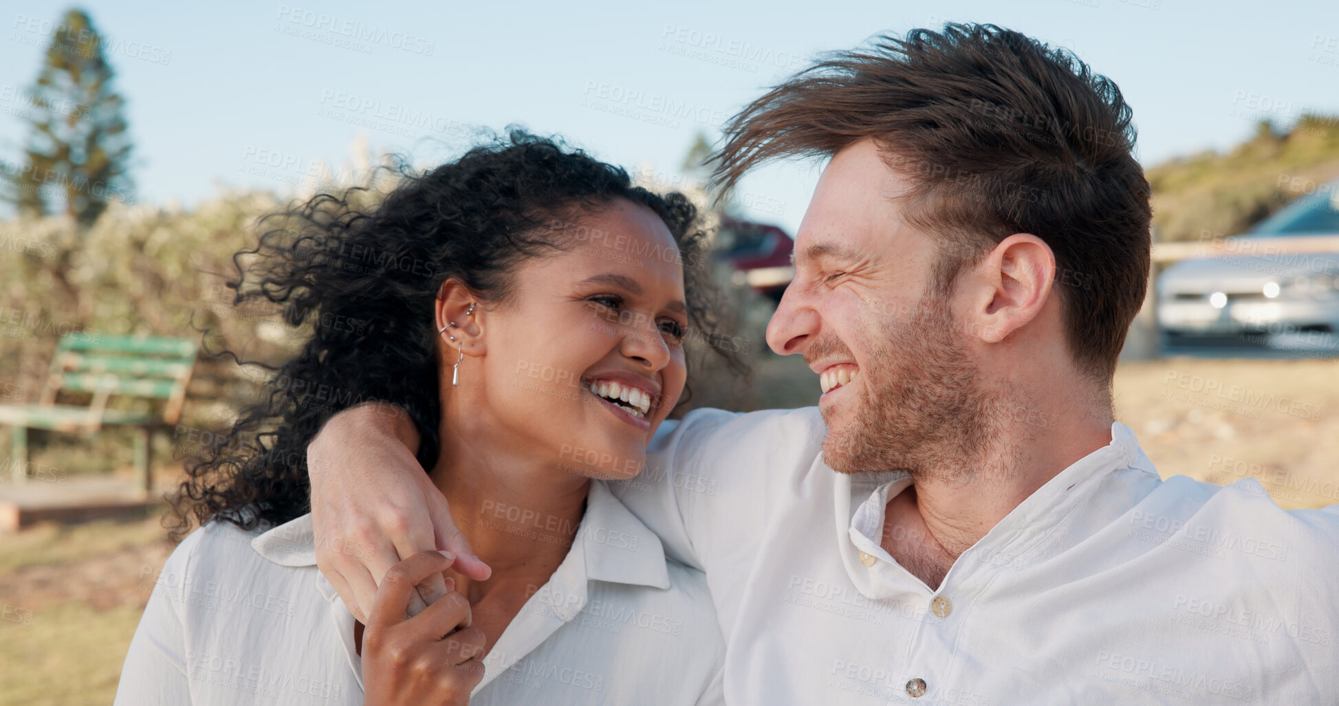 Buy stock photo Happy, interracial couple and laughing together outdoor for funny joke, relationship support and romantic weekend. Date, people and relax in nature for travel holiday, trust or commitment in marriage