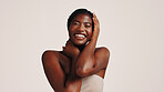 Skincare, wellness and black woman in studio with natural, health or beauty routine. Happy, space and African female person with dermatology facial treatment for face glow by white background.