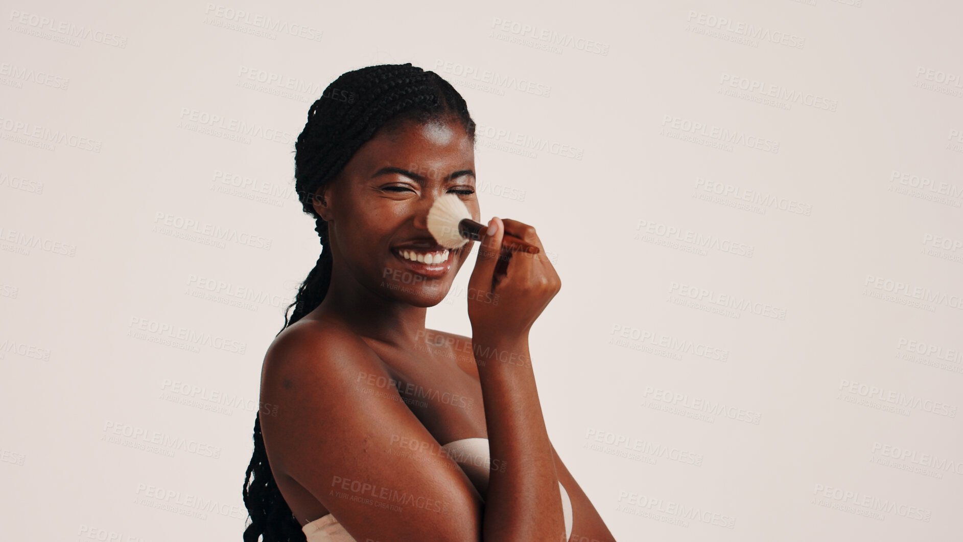 Buy stock photo Brush, cosmetics and black woman in studio with face, beauty or makeup for getting ready. Happy, cosmetology and African female person with blush for facial color or glow by white background.