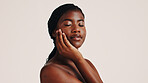 Skincare, calm and black woman in studio with natural, health or wellness routine. Space, beauty and African female person with dermatology facial treatment for face glow by white background.