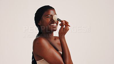 Buy stock photo Brush, beauty and black woman in studio with face, makeup or cosmetics for getting ready. Happy, cosmetology and African female person with blush for facial color or glow by white background.