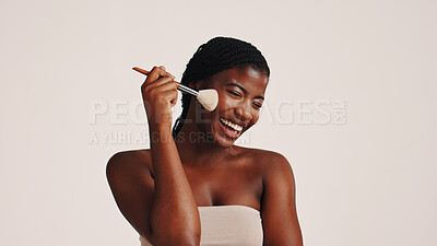 Buy stock photo Brush, happy and black woman in studio with makeup, beauty or cosmetics for getting ready. Smile, cosmetology and African female person with blush for facial color or glow by white background.