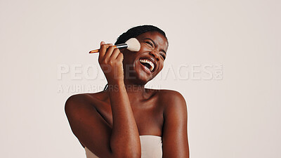 Buy stock photo Brush, laughing and black woman in studio with makeup, beauty or cosmetics for getting ready. Happy, cosmetology and African female person with blush for facial color or glow by white background.